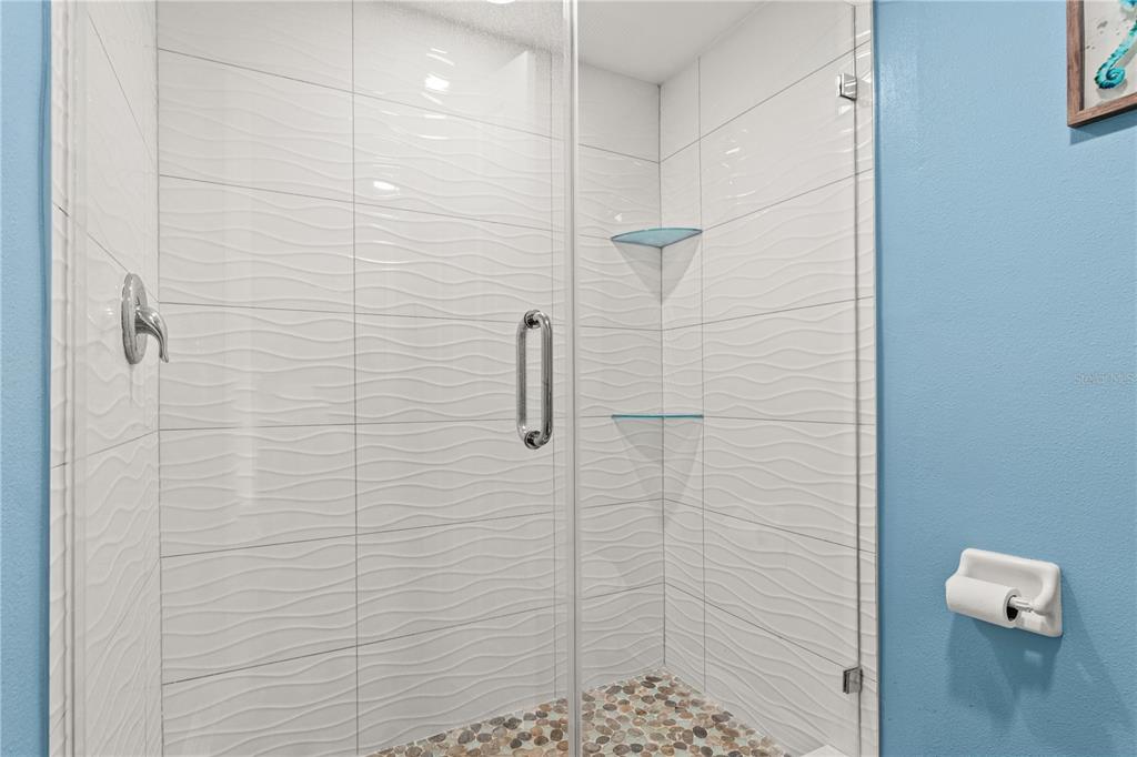 6035 Sea Ranch Drive, Unit 415 Hudson, FL 34667 - Photo 28 of 49 a bathroom with a shower