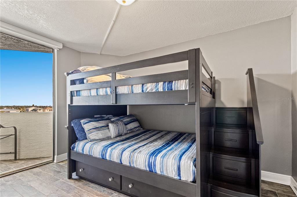 6035 Sea Ranch Drive, Unit 415 Hudson, FL 34667 - Photo 29 of 49 a bedroom with a bed and a window