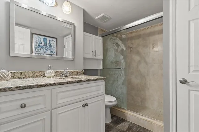 a bedroom with a bed and dresser with mirror