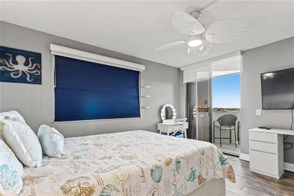 a white bed in a room next to a window