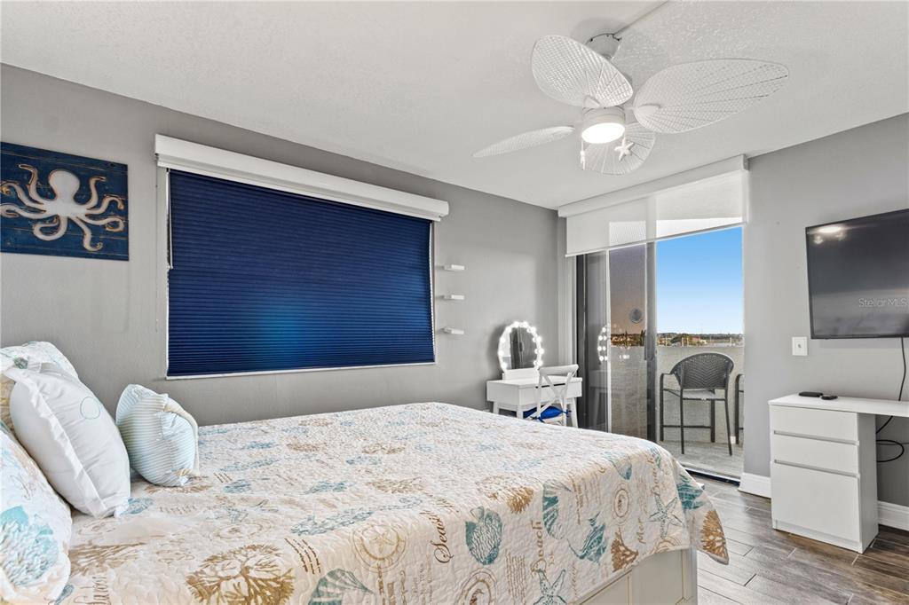 6035 Sea Ranch Drive, Unit 415 Hudson, FL 34667 - Photo 35 of 49 a bedroom with a bed and a chandelier