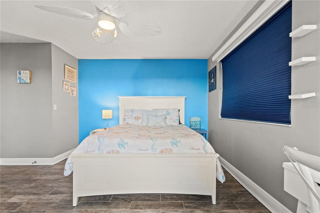 6035 Sea Ranch Drive, Unit 415 Hudson, FL 34667 - Photo 36 of 49 a white bed in a room next to a window
