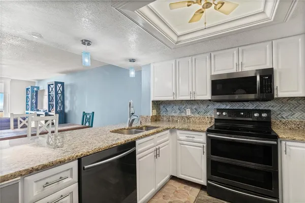 a kitchen with a sink stove and microwave