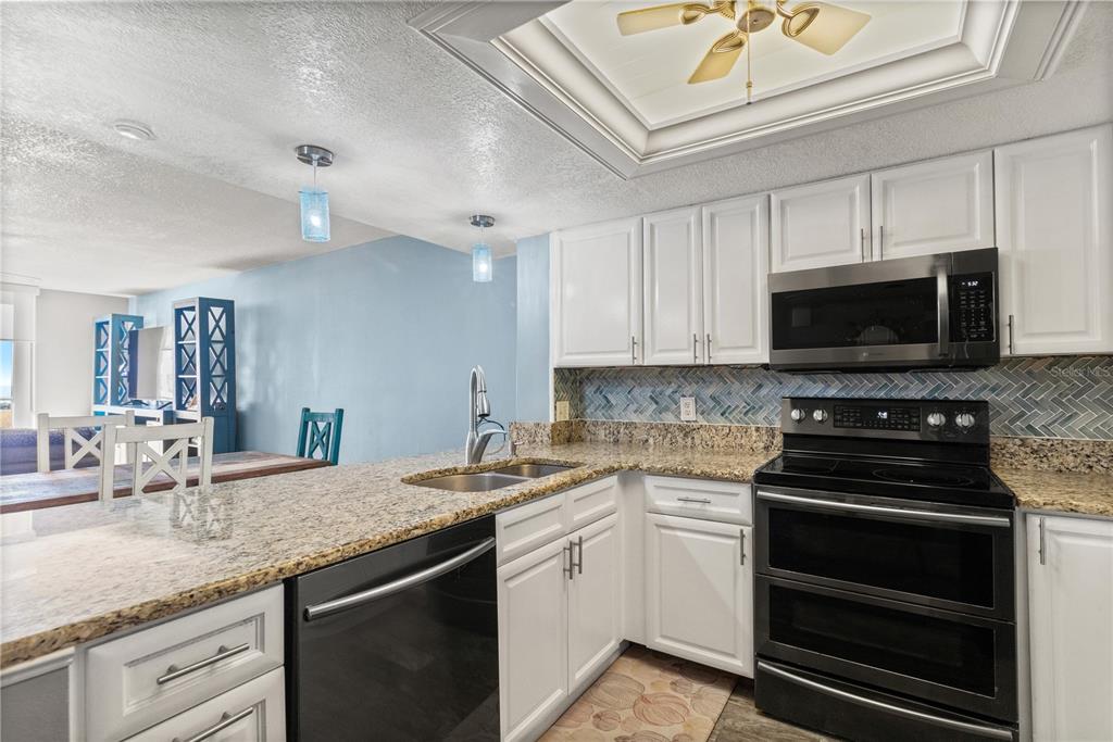 6035 Sea Ranch Drive, Unit 415 Hudson, FL 34667 - Photo 10 of 49 a kitchen with a sink stove and microwave