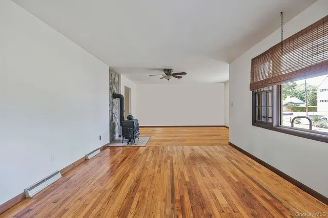 a very nice looking room with wooden floor and furniture