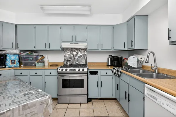 a kitchen with refrigerator and cabinets
