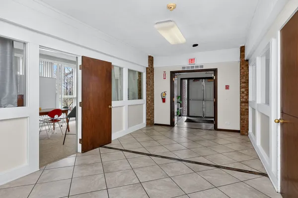 a view of a hallway with wooden shelves