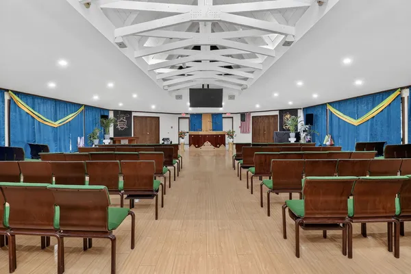 a living room with stainless steel appliances kitchen island granite countertop furniture and a rug
