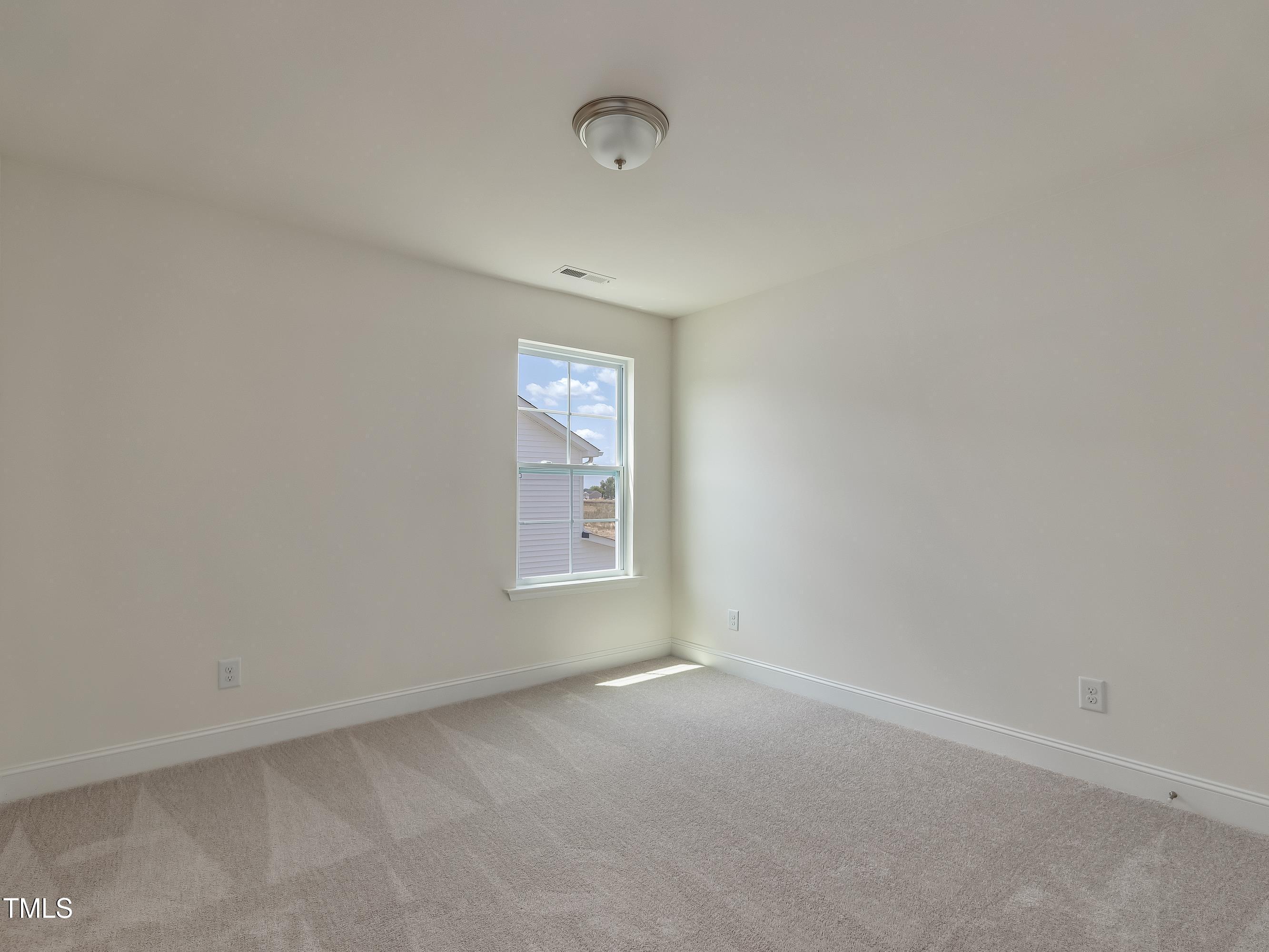 1028 Channel Drop Loop Zebulon, NC 27597 - Photo 10 of 22 an empty room with a window