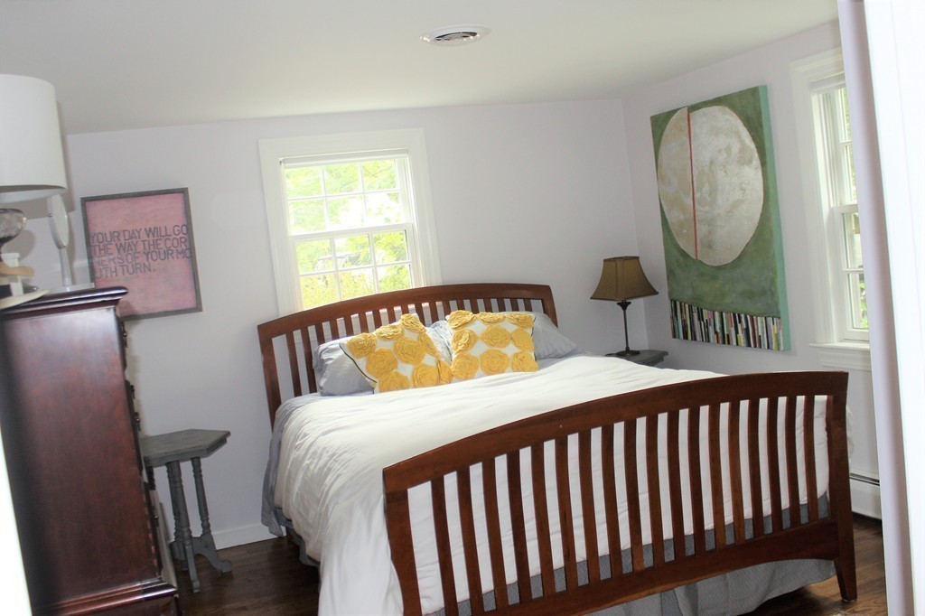 1672 Main Road Westport, MA 02790 - Photo 18 of 26 a bedroom with a bed a mirror and a window