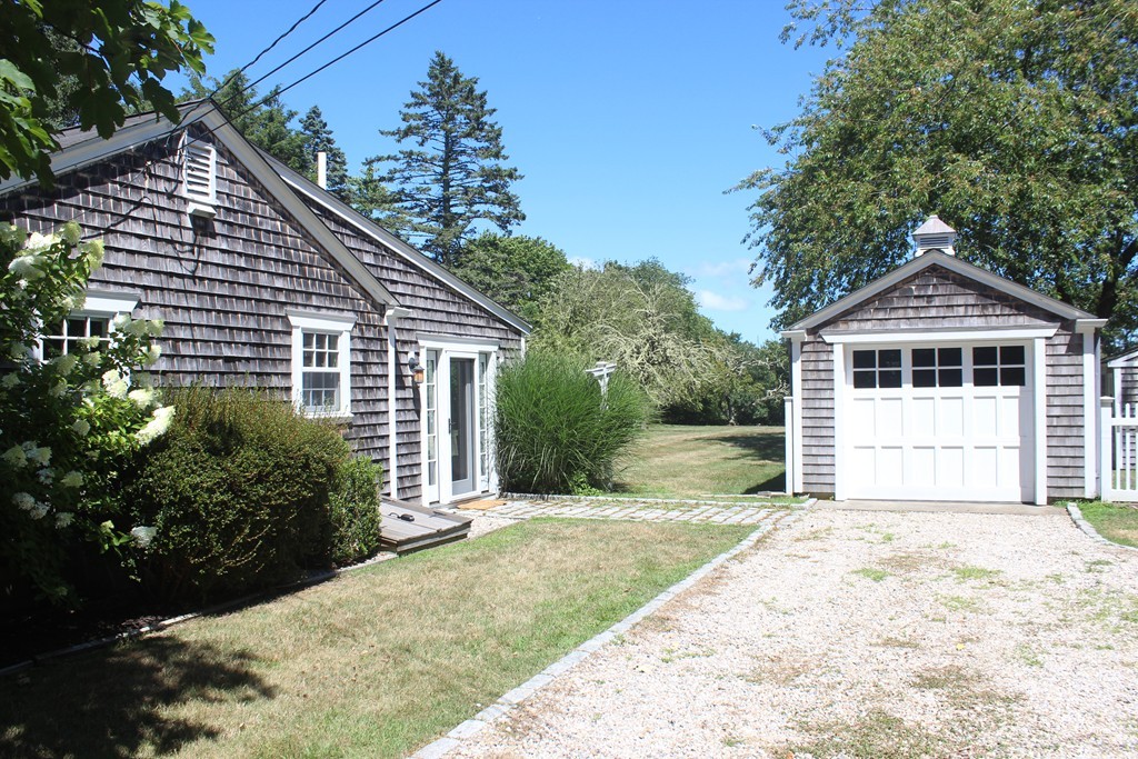 1672 Main Road Westport, MA 02790 - Photo 3 of 26 a front view of a house with a yard and garage
