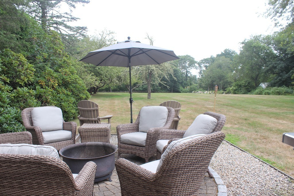 1672 Main Road Westport, MA 02790 - Photo 4 of 26 a backyard of a house with a table and chairs