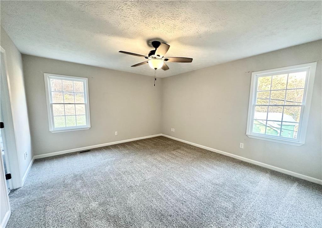 9725 Kings Road Gainesville, GA 30506 - Photo 11 of 32 a view of an empty room with a window