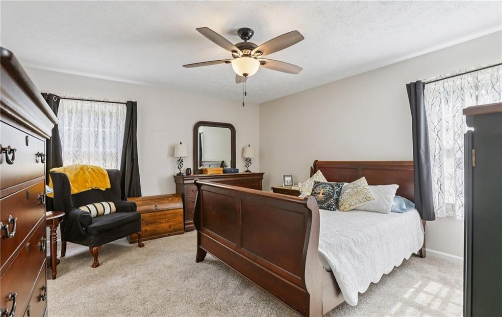9725 Kings Road Gainesville, GA 30506 - Photo 12 of 32 a bedroom with a bed and wooden floor