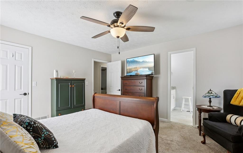 9725 Kings Road Gainesville, GA 30506 - Photo 13 of 32 a bedroom with a bed and furniture