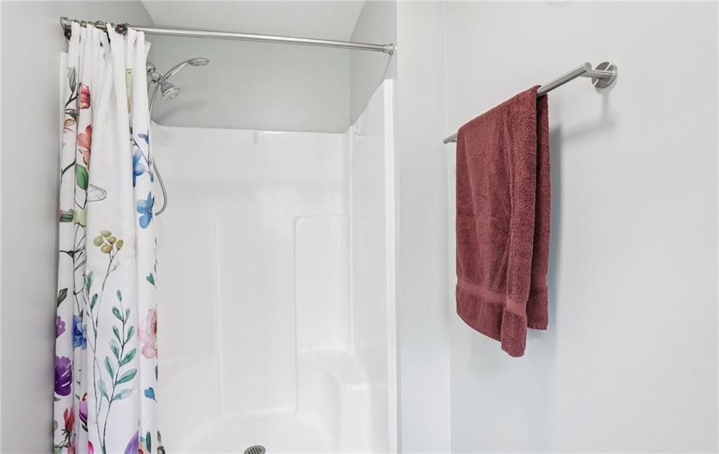 9725 Kings Road Gainesville, GA 30506 - Photo 17 of 32 a bathroom with a shower curtain and a shower curtain
