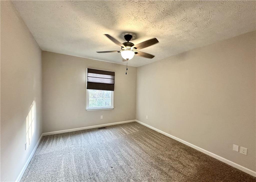 9725 Kings Road Gainesville, GA 30506 - Photo 19 of 32 wooden floor in an empty room with a window