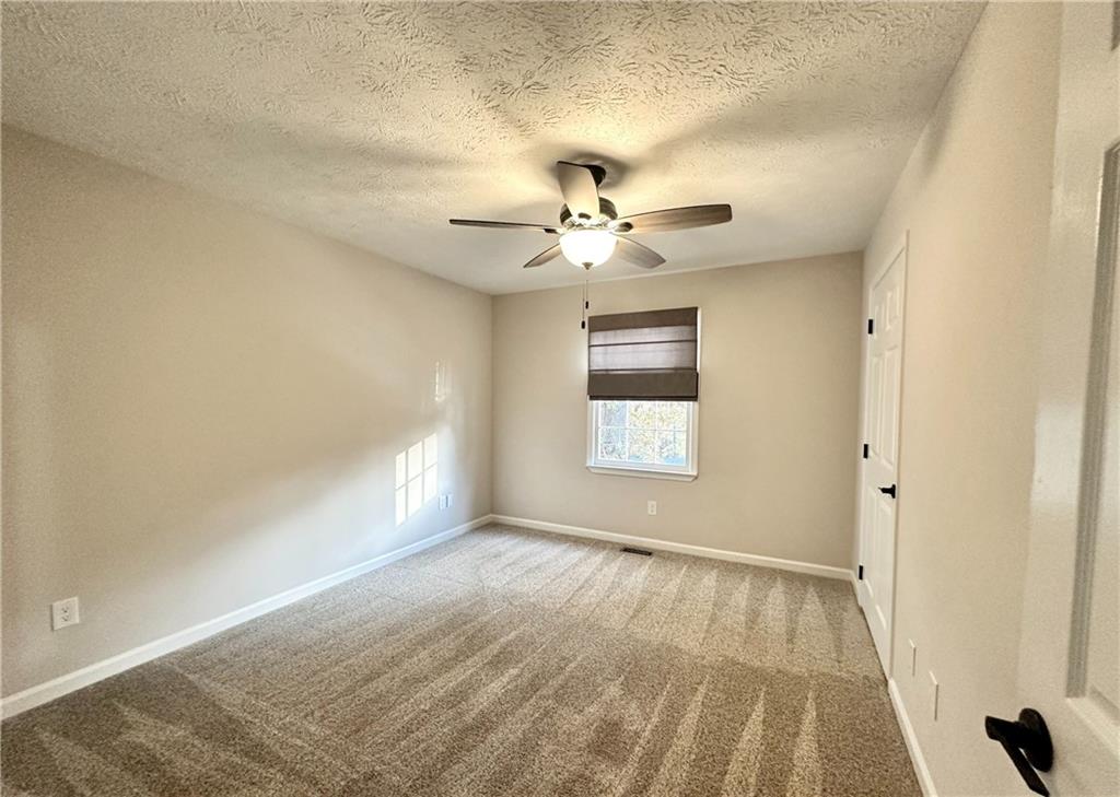 9725 Kings Road Gainesville, GA 30506 - Photo 20 of 32 a view of a room with a ceiling fan and a window