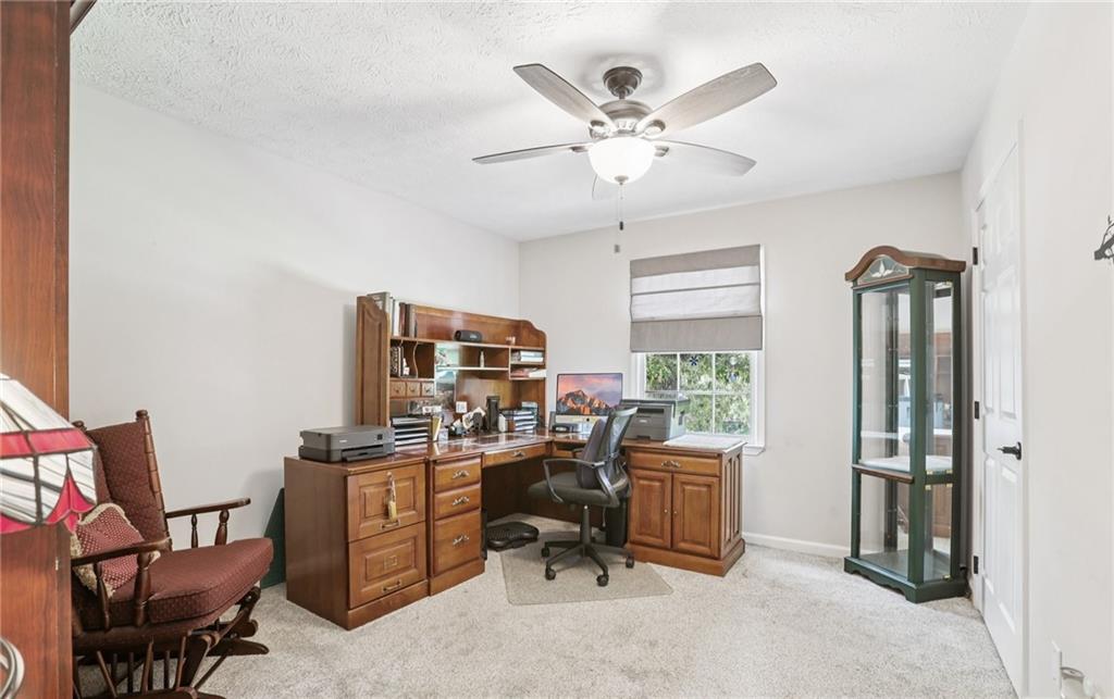 9725 Kings Road Gainesville, GA 30506 - Photo 22 of 32 a view of a workspace with furniture and a window