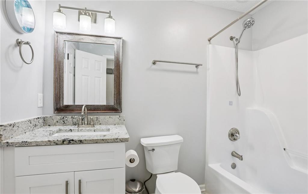 9725 Kings Road Gainesville, GA 30506 - Photo 24 of 32 a bathroom with a granite countertop sink toilet and shower