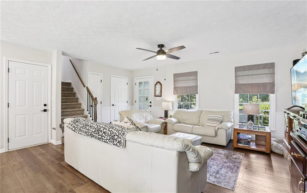 9725 Kings Road Gainesville, GA 30506 - Photo 25 of 32 a living room with furniture and a chandelier