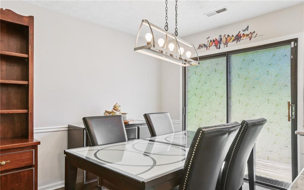 9725 Kings Road Gainesville, GA 30506 - Photo 29 of 32 a view of a dining room with furniture window and wooden floor