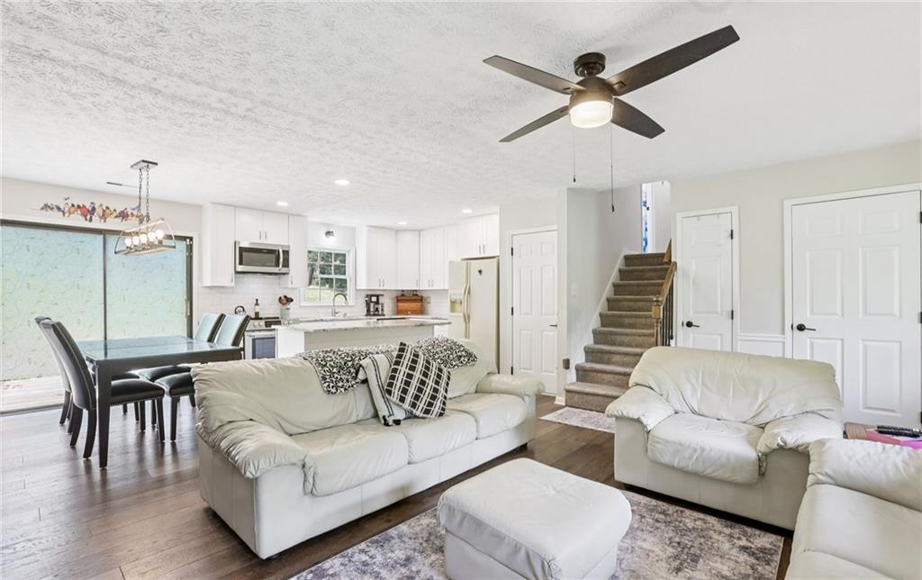 9725 Kings Road Gainesville, GA 30506 - Photo 30 of 32 a living room with furniture kitchen view and a chandelier