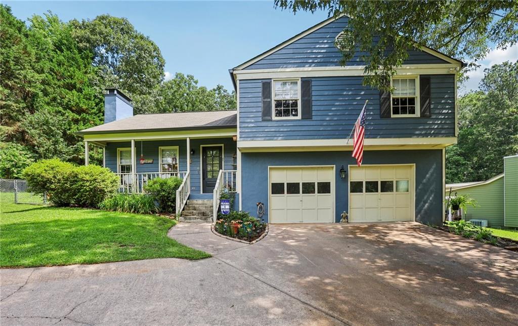 9725 Kings Road Gainesville, GA 30506 - Photo 31 of 32 a front view of a house with a yard and garage