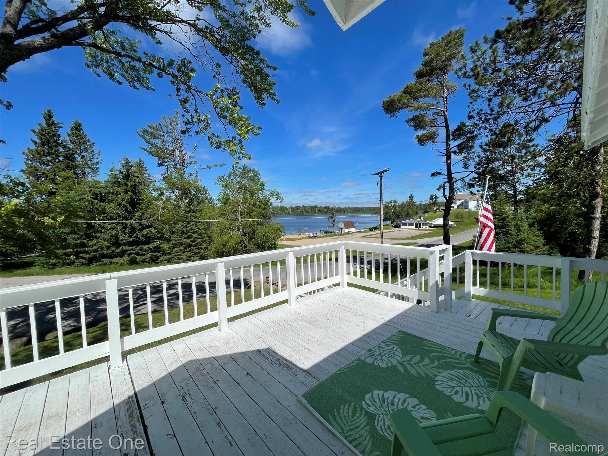 4160 Hawk Road Lincoln, MI 48742 - Photo 8 of 48 Expansive outdoor deck with white painted wood flooring and white baluster railing