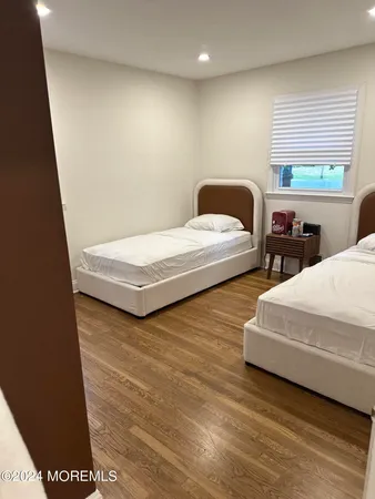 a bedroom with two beds and a large window