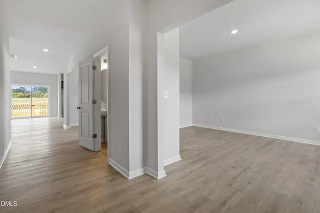 a view of a hallway with wooden floor