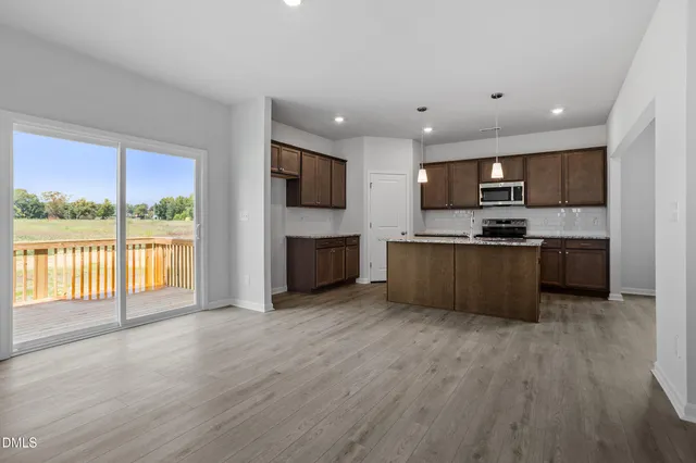 a view of kitchen with microwave and cabinets