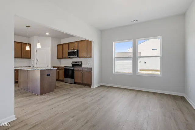 a view of kitchen with wooden floor and electronic appliances