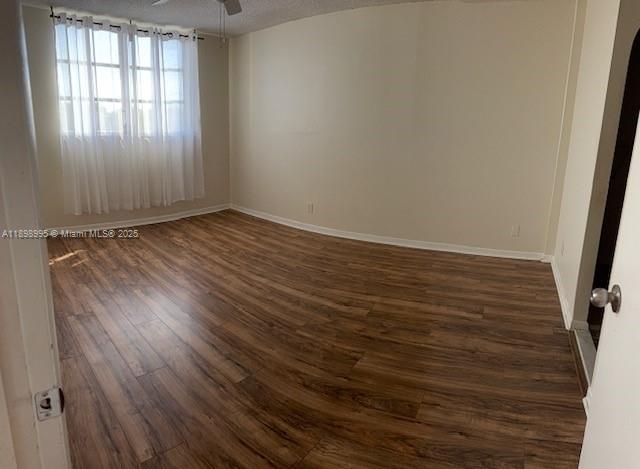 406 Northwest 68th Avenue, Unit 411 Plantation, FL 33317 - Photo 5 of 12 an empty room with wooden floor and windows