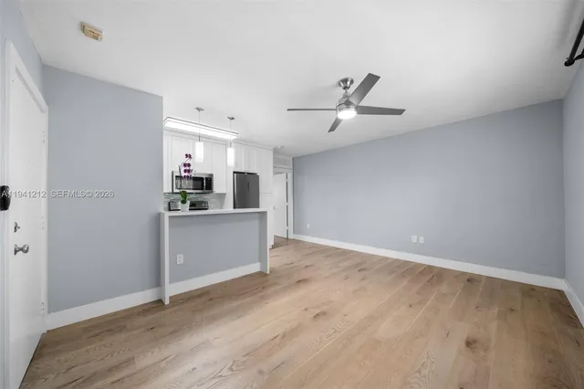 a view of a kitchen with a sink stainless steel appliances and cabinets