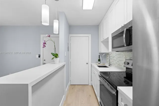 a kitchen with a sink dishwasher stove and microwave