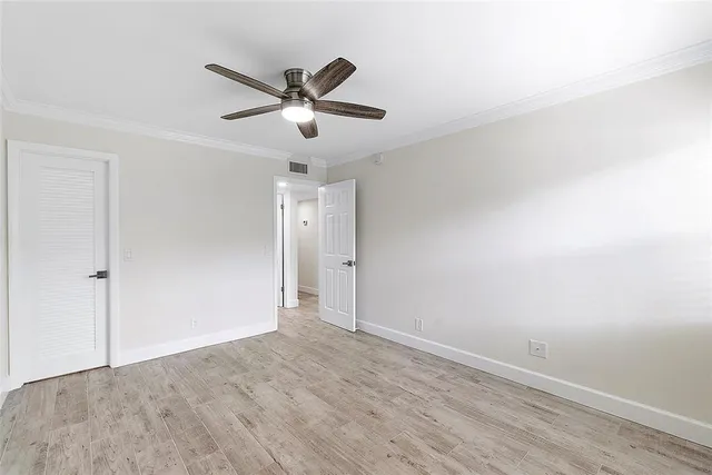a view of a big room with wooden floor and windows in a room
