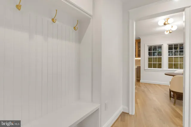 a view of a livingroom with wooden floor and a staircase