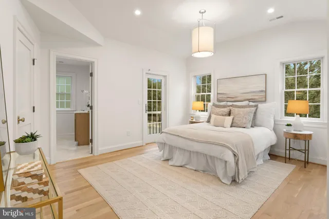 a bedroom with a large bed and a chandelier