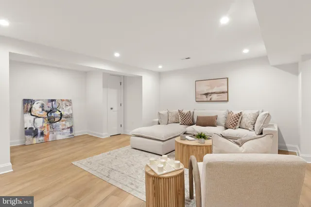 a living room with furniture and wall painting