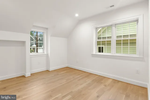 a view of a room with wooden floor and windows