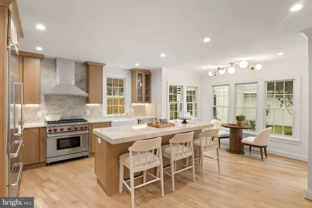 a large kitchen with a table and chairs