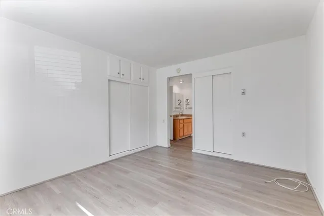 a view of an empty room and wooden floor