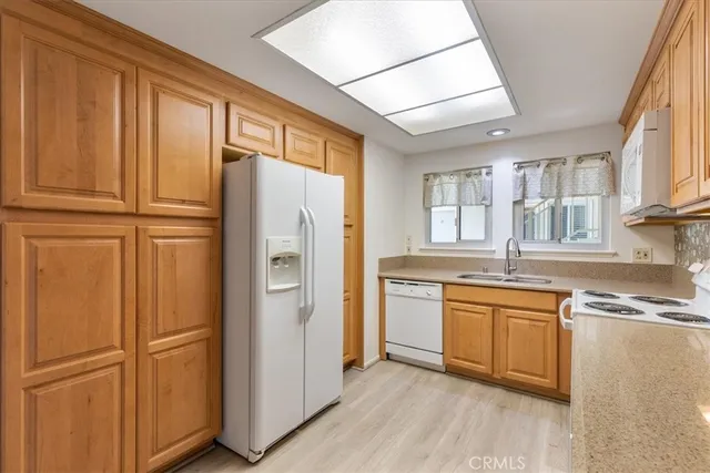 a kitchen with granite countertop stainless steel appliances and refrigerator