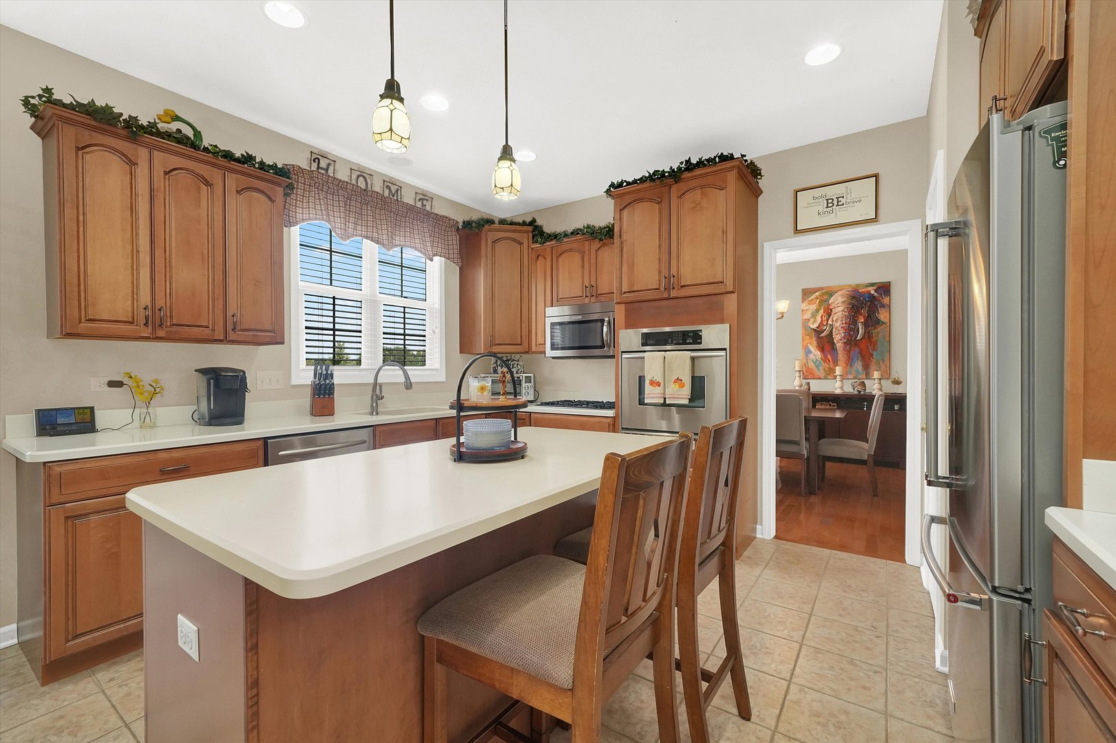 546 Caleb Road Braidwood, IL 60408 - Photo 11 of 34 a kitchen with granite countertop a table chairs refrigerator and cabinets