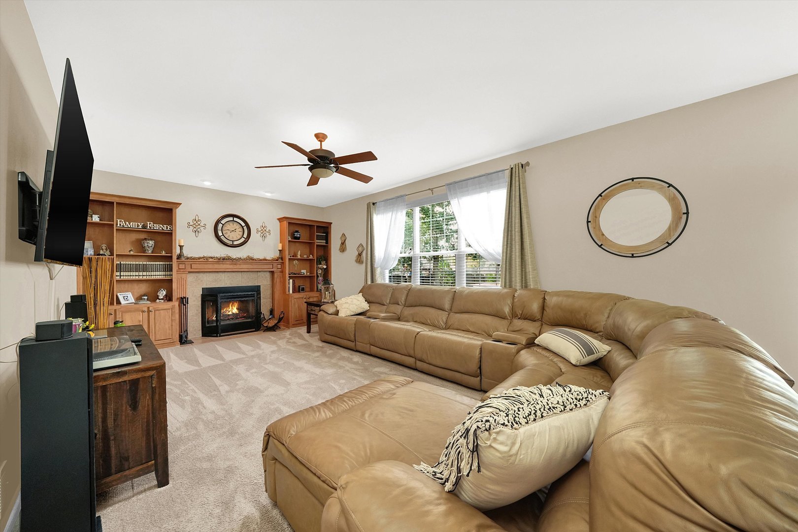 546 Caleb Road Braidwood, IL 60408 - Photo 12 of 34 a living room with furniture a fireplace and a flat screen tv