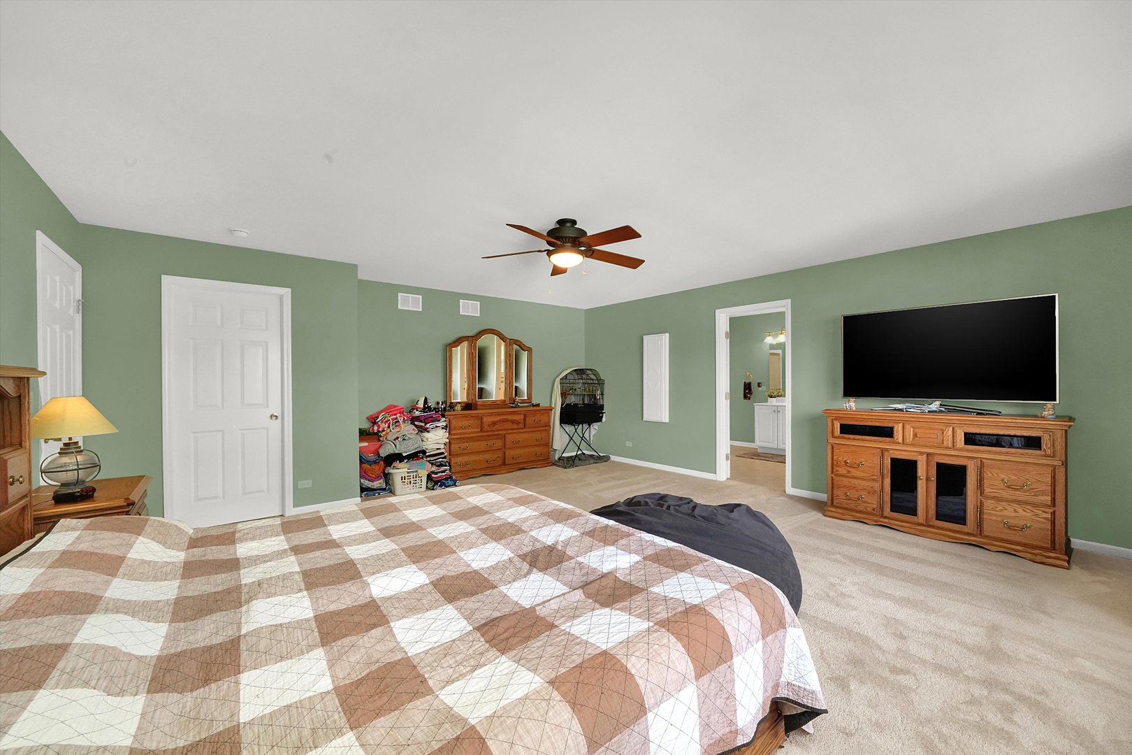 546 Caleb Road Braidwood, IL 60408 - Photo 16 of 34 a bedroom with a bed and a flat screen tv