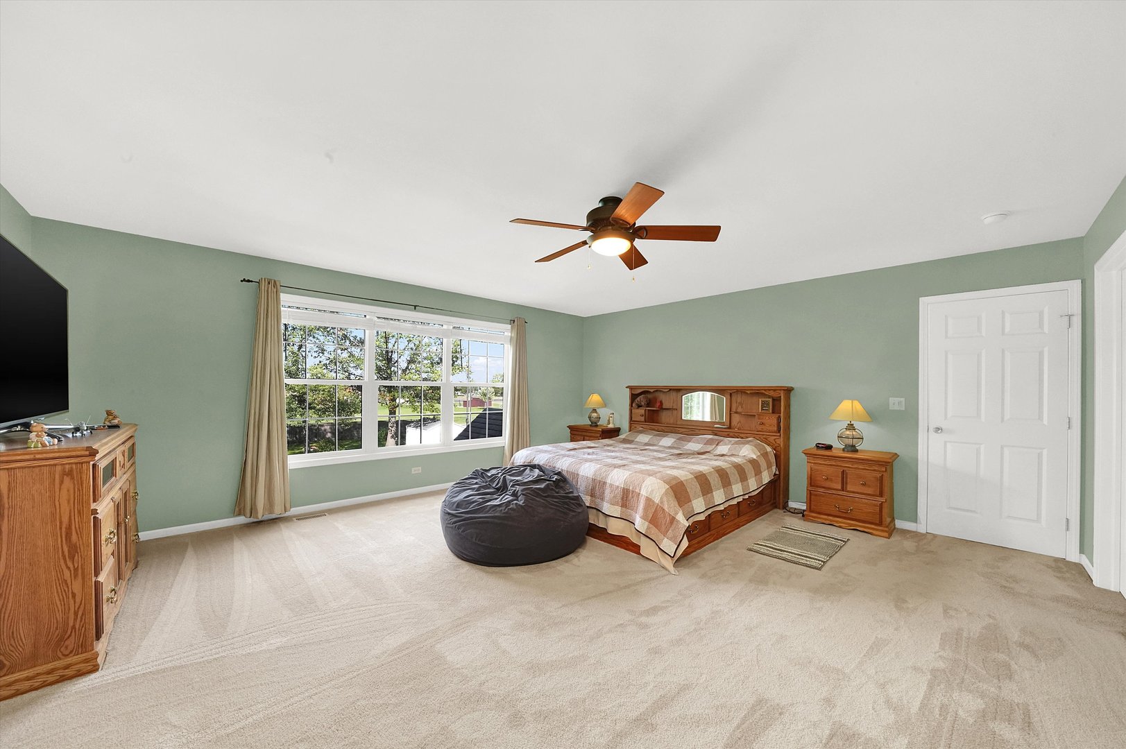 546 Caleb Road Braidwood, IL 60408 - Photo 17 of 34 a spacious bedroom with a bed and large window