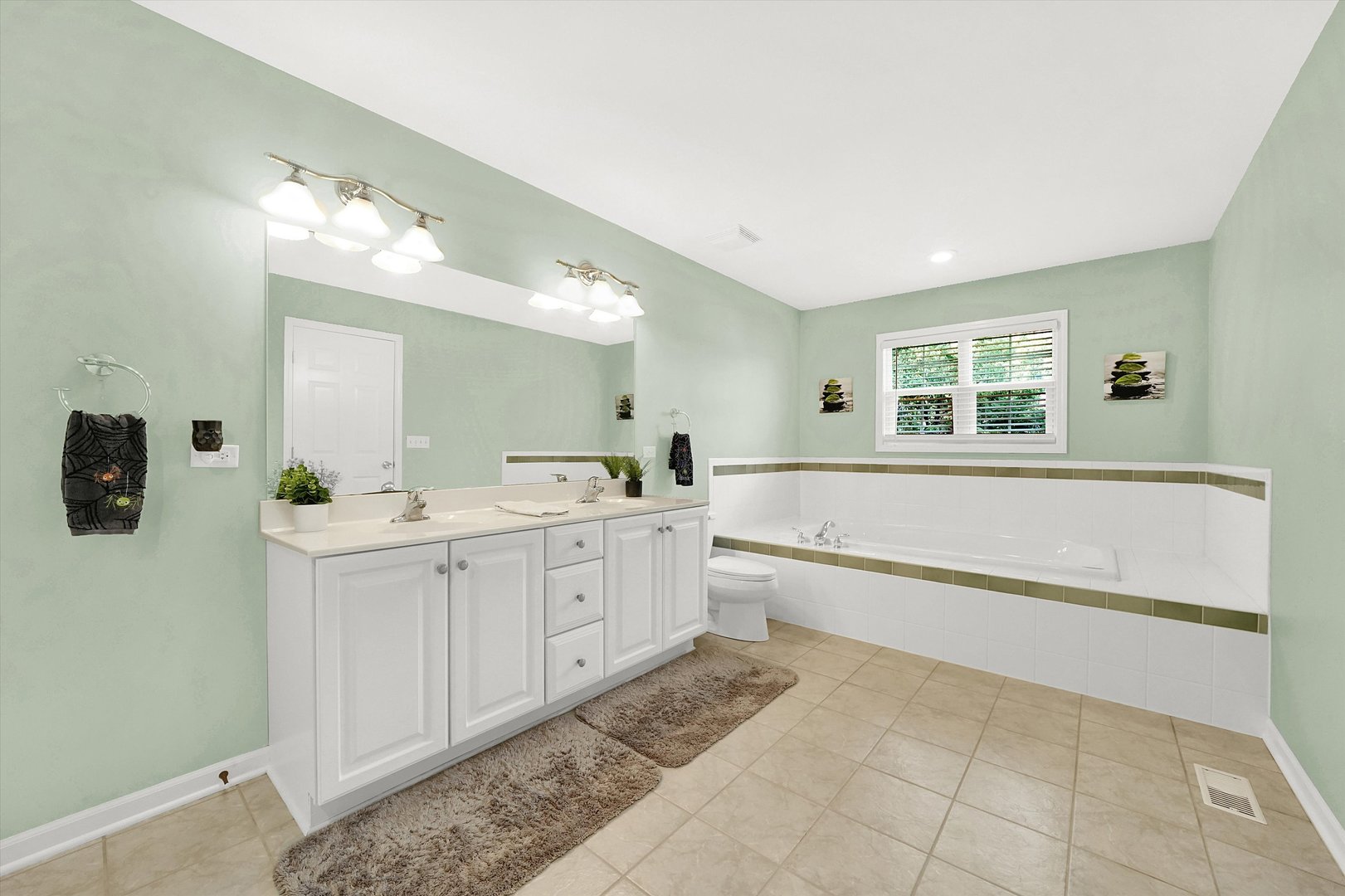 546 Caleb Road Braidwood, IL 60408 - Photo 19 of 34 a spacious bathroom with a double vanity sink a mirror and a bathtub
