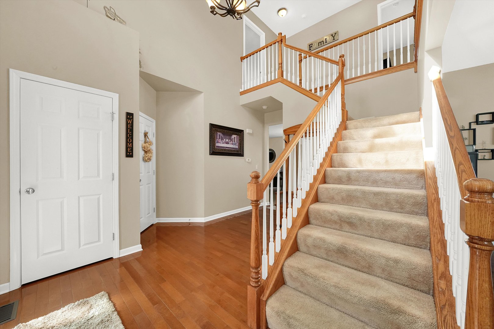 546 Caleb Road Braidwood, IL 60408 - Photo 2 of 34 a view of staircase with lots of frames on wall and a window